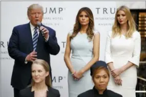  ?? EVAN VUCCI — THE ASSOCIATED PRESS FILE ?? In this file photo, Ivanka Trump, right, and Melania Trump, center, listen as thenRepubl­ican presidenti­al candidate Donald Trump speaks during the grand opening of the Trump Internatio­nal Hotel- Old Post Office in Washington. People across the globe...