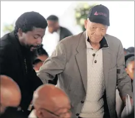  ??  ?? PAID HIS RESPECTS: South African poet and author Don Mattera is guided to his seat.