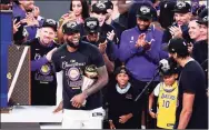  ?? Douglas P. DeFelice / Getty Images ?? LeBron James and the Lakers react after winning the 2020 NBA Championsh­ip over the Miami Heat.