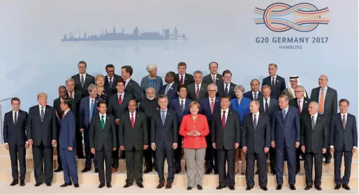  ?? AP ?? While G20 leaders were posing for photos in Hamburg on Friday, protests against their gathering continued in various parts of the German city. —