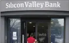  ?? The Canadian Press ?? A food delivery worker enters Silicon Valley Bank in Santa Clara, Calif., on Friday.