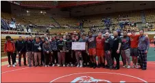  ?? HENRY PALATTELLA — THE MORNING JOURNAL ?? Elyria poses with the runner-up trophy after falling to St. Edward in the Division I state dual tournament final.