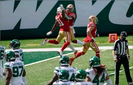  ?? AP Photo/Corey Sipkin ?? San Francisco 49ers running back Raheem Mostert (31) celebrates with teammates after scoring a touchdown during the first half of an NFL football game against the New York Jets, ON Sunday in East Rutherford, N.J.