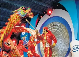  ?? Le Quang Nhat
Associated Press ?? INTEL IS adding more complex products made at its semiconduc­tor factory in Ho Chi Minh City, Vietnam. Above, a dragon dance is performed at the opening ceremony of the facility in 2010.