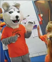  ??  ?? North Broad Street’s new mascot gives out high fives during a special ceremony on Monday.