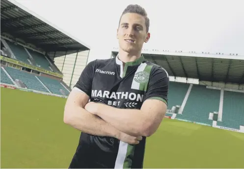  ??  ?? 0 Paul Hanlon models the new Hibs away kit, which they will wear in their first season back in the top flight since 2014.