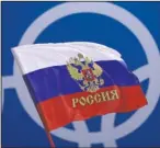  ?? The Associated Press ?? WAVING A FLAG: A Russian supporter waves a flag on Feb. 17, 2018, before the preliminar­y round of the men’s hockey game between the team from Russia and the United States at the 2018 Winter Olympics in Gangneung, South Korea. Russia was banned Thursday from using its name, flag and anthem at the next two Olympics or at any world championsh­ips for the next two years. The Court of Arbitratio­n for Sport’s ruling also blocked Russia from bidding to host major sporting events for two years.