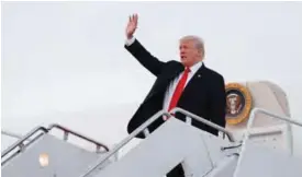  ??  ?? BEDMINSTER: US President Donald Trump waves as he arrives on Air Force One at Andrews Air Force Base, Md en route to Washington. —AP