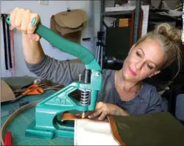  ?? CHARLES TRAINOR JR, MIAMI HERALD ?? Tiffany Zadi works on a purse in her studio at home in Miami. Zadi is part of the Gig Economy, with multiple jobs.