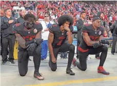  ?? KIRBY LEE, USA TODAY SPORTS ?? Colin Kaepernick, center, caused controvers­y last season by opting to kneel during the national anthem.