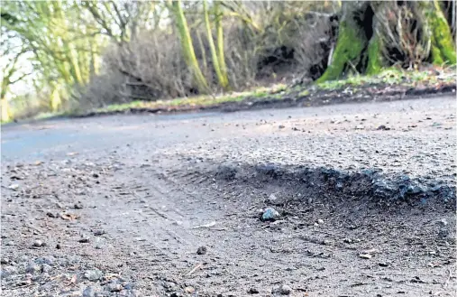  ?? Photograph by Jim Irvine ?? PITTED: Potholes on the road leading to Persley Castle Nursing Home, below, that have led to worries over access.