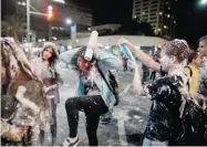  ?? URIEL SINAI/ GETTY IMAGES ?? Israeli children play with foam spray in Tel Aviv during Israel’s 65th Independen­ce Day on Tuesday.