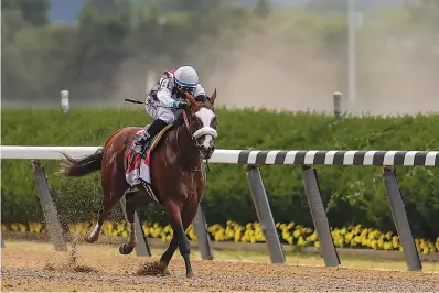  ?? AP Photo/Seth Wenig ?? ■ Tiz the Law (8), with jockey Manny Franco up, approaches the finish line on his way to win the152nd running of the Belmont Stakes horse race Saturday in Elmont, N.Y.