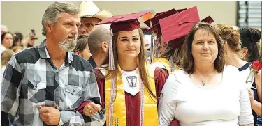  ??  ?? Destiny Bolles, with her father and mother, waited to go on stage to receive her high-honor medallion during graduation ceremonies on Sunday afternoon.