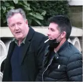 ??  ?? STEPS: Piers on his walk with Simon Cowell
