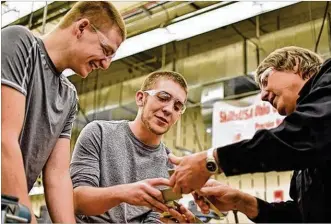  ?? CONTRIBUTE­D ?? Students Chris Heisey and Jake Blevins work with their instructor, Keith Bernheisel, in a computer-aided manufactur­ing course at Sinclair Community College. The manufactur­ing program could be included in a proposed skilled trades center at the school.