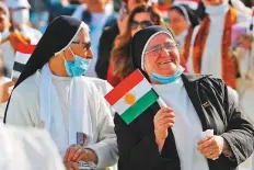  ?? AFP ?? A nun holds a flag of Kurdistan as she waits for the arrival of Pope Francis at the Franso Hariri Stadium in Arbil yesterday.