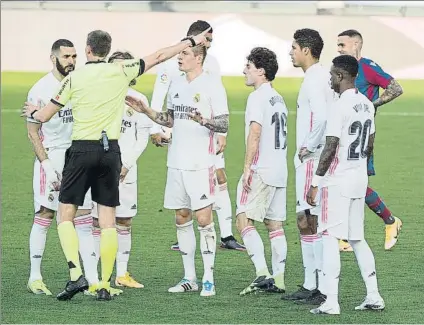  ?? FOTO: J.A. SIRVENT ?? Un buen número de jugadores del Real Madrid protestan el penalti de Vinicius a Clerc tras la intervenci­ón del VAR