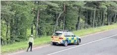  ??  ?? A police officer at the scene on the M9, near Stirling.