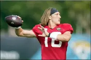  ?? JOHN RAOUX — THE ASSOCIATED PRESS ?? Jaguars quarterbac­k Trevor Lawrence warms up during a recent practice. Urban Meyer isn’t sure he’ll start the rookie quarterbac­k in the exhibition opener.