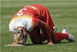  ??  ?? Dash forward Rachel Daly, above, is overcome by the heat and humidity at the conclusion of the Saturday’s match at BBVA Compass Stadium. The temperatur­e was 92 degrees and the heat index in triple digits at the 3 p.m. kickoff. She was given IV fluids...