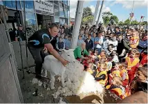  ??  ?? James Fagan shears a lamb in a demonstrat­ion for schoolchil­dren.