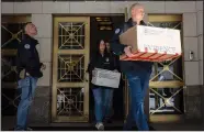  ?? (File Photo/AP/Yuki Iwamura) ?? Federal agents carry evidence boxes Sept. 1 as they walk out of a Park Avenue high-rise in New York. They were searching properties linked to Viktor Vekselberg, a billionair­e Russian oligarch. Oligarch was one of the top 10 most searched terms on merriam-webster. com in 2022.