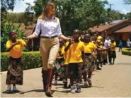  ?? AP PHOTO/CAROLYN KASTER ?? First lady Melania Trump walks with children Friday as she visits the Nest Orphanage in Limuru, Kenya.