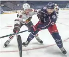  ?? ADAM CAIRNS/COLUMBUS DISPATCH ?? Blue Jackets captain Nick Foligno (71) battles Blackhawks defenseman Nikita Zadorov for the puck in the first period Thursday.