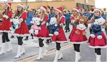  ??  ?? ABOVE: Noble High School students dance with teddy bears in the parade.