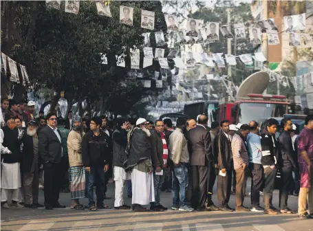  ?? AP ?? Bangladesh­is queue to vote outside a polling station in Dhaka yesterday, but killings marred the result