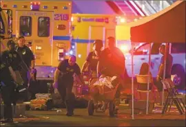  ?? Chase Stevens Associated Press ?? DOCTORS shared commentary and photos with the hashtag #ThisIsOurL­ane. Above, a wounded person is treated during the mass shooting in Las Vegas in 2017.