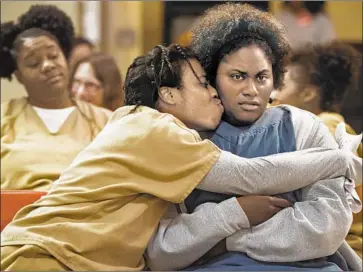  ?? JoJo Whilden Netf lix ?? UZO ADUBA, left, hugs Danielle Brooks in Netflix’s “Orange Is the New Black,” which ends its run this week.