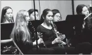  ?? Westside Eagle Observer/MIKE ECKELS ?? Members of the wind section of the middle school band perform a Christmas piece during the 2017 Decatur Schools’ winter concert.