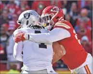  ?? Peter Aiken / Associated Press ?? Kansas City Chiefs defensive end Frank Clark, right, sacks Las Vegas Raiders quarterbac­k Derek Carr on Sunday in Kansas City, Mo.