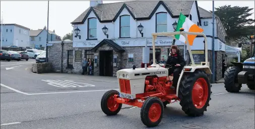  ?? Photo by Michael G Kenny ?? Flying the flag! John Mulvihill The Red Fox Inn Glenbeigh leads the annual Red Fox Tractor Run through Glenbeigh on Sunday last, The event was supported by over 160 tractors from throughout the county and beyond. The event was in aid of Daffodil Nurses...