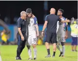  ?? REBECCA BLACKWELL/ASSOCIATED PRESS ?? Christian Pulisic (10) of the United States is comforted after the team was a 2-1 loser to host Trinidad and Tobago in their World Cup qualifying match.