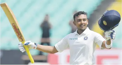  ?? Picture: AFP ?? WONDERBOY. India’s Prithvi Shaw raises his bat after scoring his century on debut on the first day of the first Test against the West Indies in Rajkot yesterday.