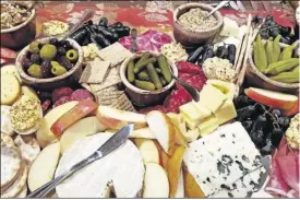  ?? LAURA TOLBERT ?? The fun part of a charcuteri­e board is you can choose a great variety of meats, cheese, di erent types of bread, crackers and fruit.
