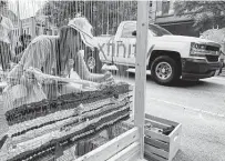  ?? Dug Begley / Staff photograph­er ?? Laura Rocha with Houston Public Works weaves fabric during a Park(ing) Day event Friday. The nationwide event raises awareness to the space used by vehicles.