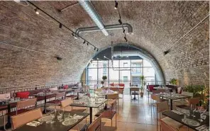  ?? Andy Haslam photos / The New York Times ?? Inside Bala Baya, an Israeli-Bauhaus restaurant that serves small plates, located at the Old Union Yard Arches in London.