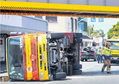  ?? Photos / Tania Whyte ?? Clockwise from above: The driver of this rubbish truck crashed its hoist into a rail bridge; Colleen Donker was nearly crushed by the hoist; Frances Morrison (left) with brother Kent Morrison after the car she was in left the road; Donker’s car.