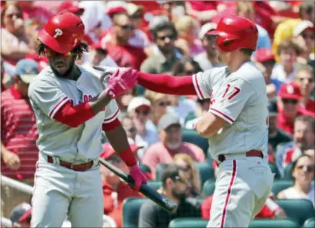  ?? JEFF ROBERSON — THE ASSOCIATED PRESS ?? The Phillies’ Rhys Hoskins, right, is congratula­ted by teammate Odubel Herrera after Hoskins hit a solo home run in the fourth inning Sunday in St. Louis. It was the only run and one of two hits allowed by Cardinals starter Jack Flaherty.