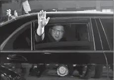  ?? KOREA SUMMIT PRESS POOL VIA AP ?? North Korea leader Kim Jong Un waves from a car as he returns to North Korea after the meeting Friday with South Korea President Moon Jae-in at the border village of Panmunjom.