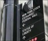  ?? RICHARD DREW — THE ASSOCIATED PRESS FILE ?? A street sign directs people to the New York Stock Exchange, Federal Hall, and the Statue of Liberty, in New York’s Financial District. Health care companies and banks drove U.S. stocks lower Thursday, pulling major indexes below their recent highs.