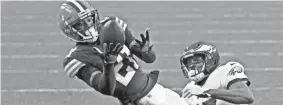  ?? KIRK IRWIN/AP ?? Cornerback Denzel Ward, here intercepti­ng a pass last week against the Philadelph­ia Eagles, is one of several Browns starters who will miss Sunday’s game at Jacksonvil­le. Ward has a calf injury.