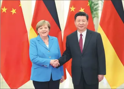  ?? WU ZHIYI / CHINA DAILY ?? President Xi Jinping greets German Chancellor Angela Merkel at the Great Hall of the People in Beijing on Thursday. In their meeting, Xi welcomed Germany to seize the opportunit­ies available as a result of China’s new round of opening-up.