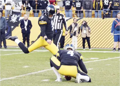  ??  ?? PITTSBURGH: Pittsburgh Steelers kicker Chris Boswell (9) kicks the game-winning field goal as Jordan Berry (4) holds in the second half of an NFL football game against the Oakland Raiders, Sunday, in Pittsburgh. — AP