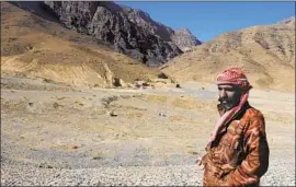  ?? Rabia Bugti For The Times ?? ABDUL HAMEED stands on a dry reservoir near his village in Pakistan’s Baluchista­n province, where most of the children suffer some degree of malnutriti­on.