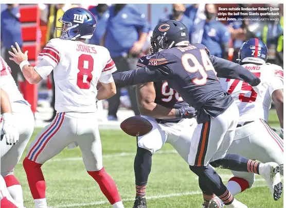  ?? JONATHAN DANIEL/GETTY IMAGES ?? Bears outside linebacker Robert Quinn strips the ball from Giants quarterbac­k Daniel Jones.